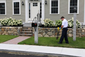 Papalia Home Services technician using underground detection equipment to inspect sewer line at residential property with stone foundation.
